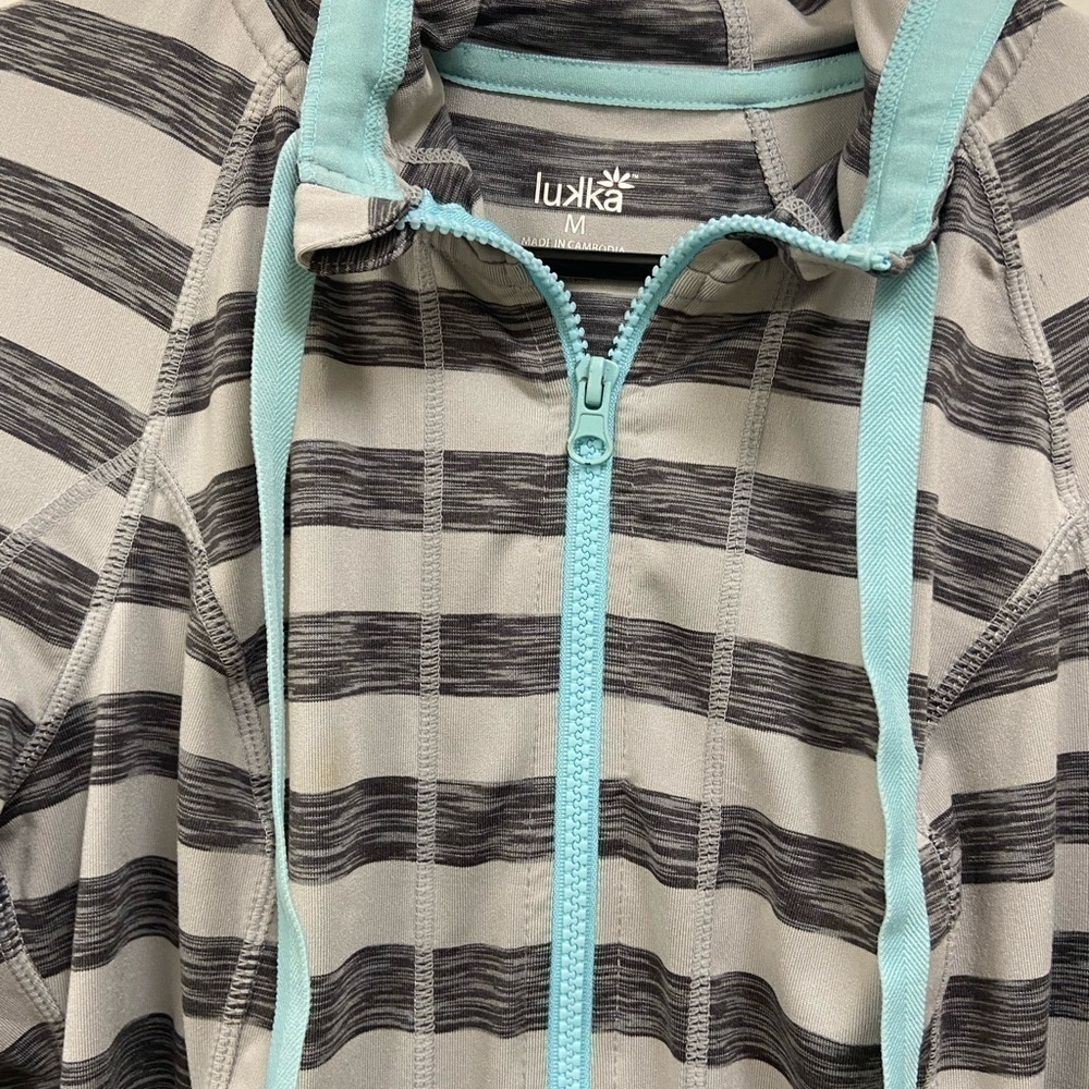 Luka athletic top jacket. Front Zipper. Grey & white striped. Size medium.